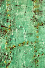 Beautiful abstract patterns and texture of rivted panels of exposed copper sheet with green aged patina