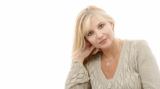Portrait of mature blond woman on white background