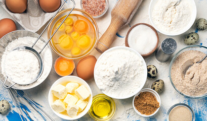 Baking ingredients on blue color background, top view