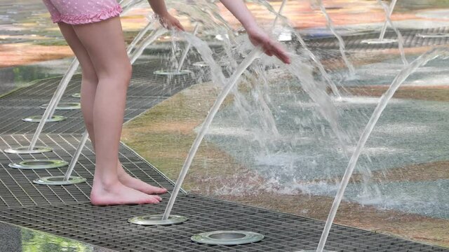 Gomel, Belarus - June 10, 2020: Children bathe in a fountain in the park Gromyko