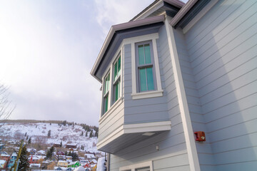 Home exterior in Park City Utah with bay window and gray horizontal wall siding - obrazy, fototapety, plakaty