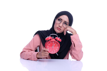 Muslim woman hold alarm clock with deference expression face with deference time conceptual