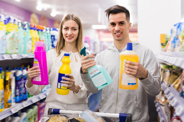 Fine couple choosing household detergents