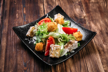 Caesar salad with fried tofu and deep-fried cheese