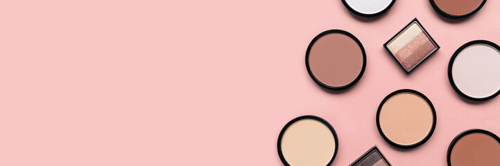 Beige blush, eyeshadow and mineral compact face powder on a pastel pink background. Banner. Place for text. Copy space. Top view. Trendy colors. Makeup. Cosmetic products. Tonal foundation. Flat lay.