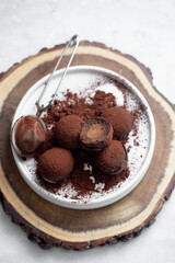 Vegetarian Chocolate Truffles With Raw Cocoa And Dates. Closeup View Of Pile Of Homemade Chocolate Truffles on white background. Chocolate Energy Balls