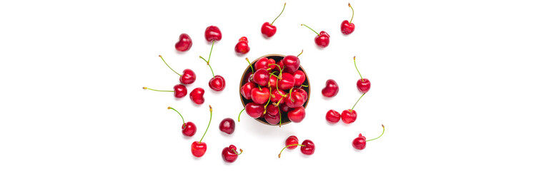 sweet organic berries in wooden cup and scattered around isolated on white background Top view Flat lay Summer harvest concept Banner