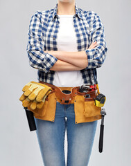 repair, construction and building concept - woman or builder with working tools on belt over grey background