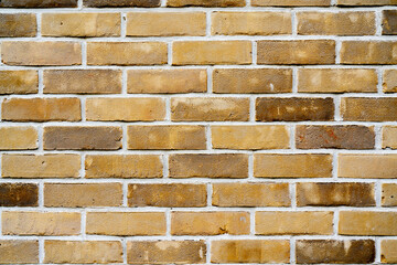 Yellow brick wall. Facade of an old building. Architectural background.