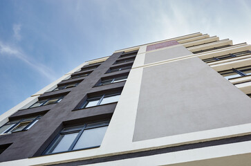Fototapeta premium Modern apartment buildings on a sunny day with a blue sky. Facade of a modern European apartment building