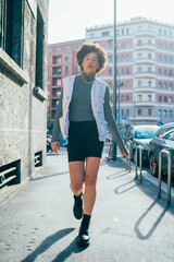 Young confident afro woman walking outdoor - Diverse woman with attitude strolling in the city