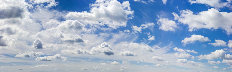 Wide panorama of the sky with cumulus and cirrus clouds