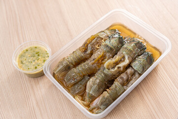 Fish Sauce Mantis Shrimp or Crayfish with spicy dipping sauce. Wooden Background