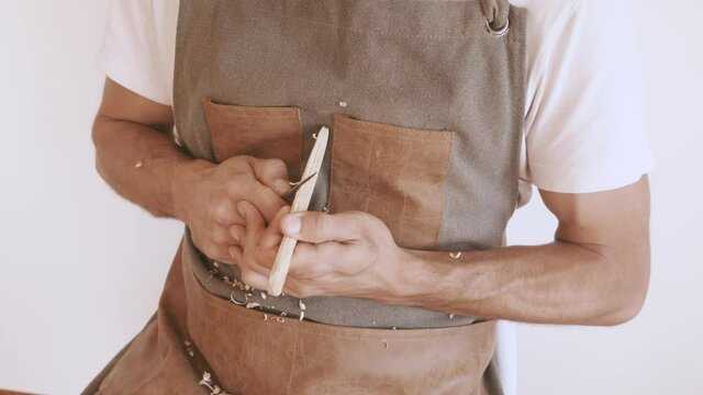footage of a man carving a wood knife