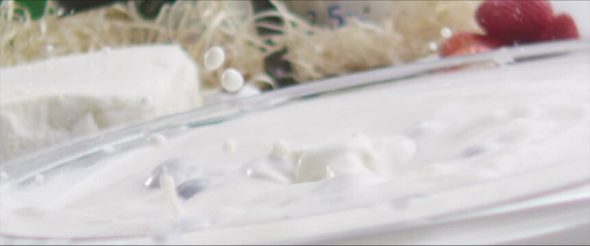 Strawberry falls into milk Slow Motion Macro