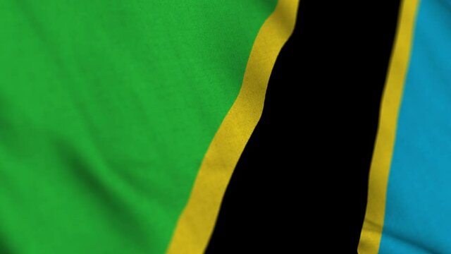 Tanzania national flag waving with fabric texture fluttering in wind in a seamless loop in smooth slowmotion animation background