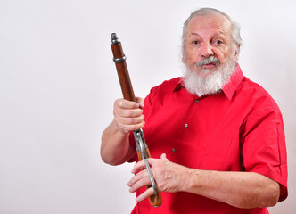 Determined looking old man with a sawed off rifle, wearing patriotic colors.  .Unsociable man not giving a welcoming look. - obrazy, fototapety, plakaty