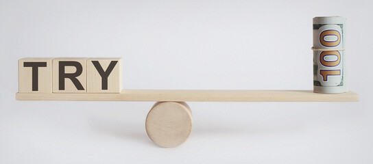 Seesaw Showing Balance Between money And word TRY