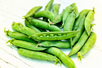 Fresh peas in the pod with one opened