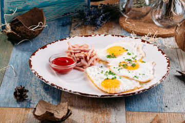 Appetizing breakfast fried eggs with ketchup