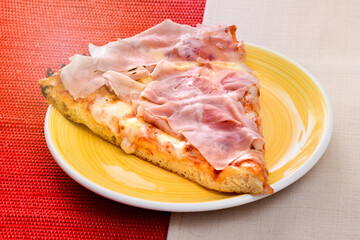 Slice of Italian pizza with ham topping