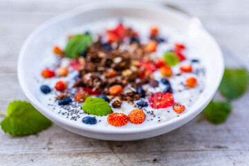 A bowl of delicious yogurt with grains and fresh berry fruit. Weight loss and healthy diet.