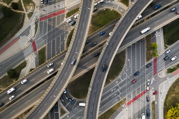 Cityscape aerial top down view over city highway and roundabout. Traffic in the city. Overpass road with vehicle movement, modern european transport construction in Warsaw, Poland.