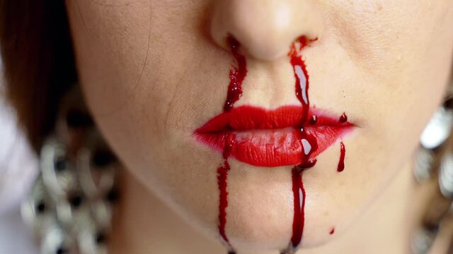 Close-up of female's tired and beaten face with heavy bleeding nose after male's aggression and violence, tyranny and family violator's actions. Crime against weak gender, freedom concept