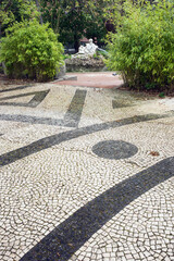 Obraz premium traditional black and white pavement named calcada in the park of Estrela, Lisbon