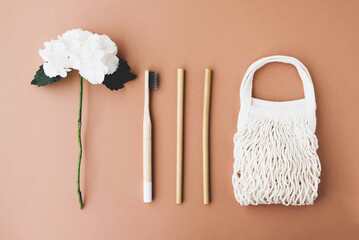 Stylish reusable eco friendly items on brown background.