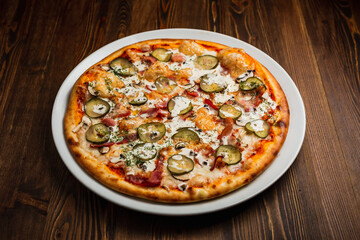 Bacon, mushroom and pickles nourishing pizza with sour cream sauce, wooden background, low key