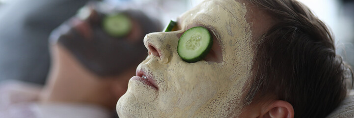 Men made clay facial cleansing mask in salon. Cleansing and matting masks for male skin prone to...