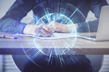 Double exposure of hands and notepad with business icons.