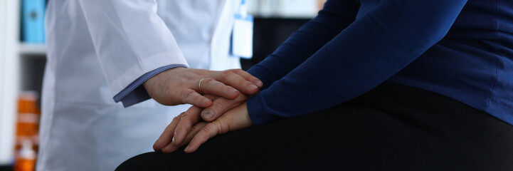 Male doctor reassures patient after examination. Memory problems and fainting. Diagnosis malignant...