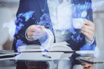 Double exposure of hands and notepad with business icons.