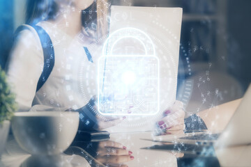 Double exposure of hands making notes with lock icons. Concept security and protection of data