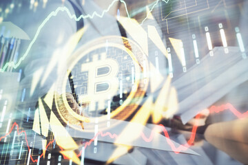 Cryptocurrency hologram over woman's hands writing background. Concept of blockchain. Double...