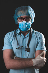 Medical doctor, nurse, surgeon, psychologist working with protective mask, glasses and gloves helping people in the days of panic, pandemic - studio shot on black background.