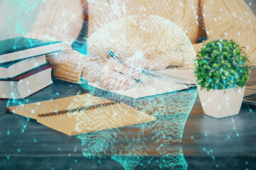 Multi exposure of writing hand on background with brain hologram. Concept of learning.