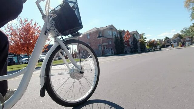 Cyclist riding an electric bicycle in the urban city area. Ecology concept. Shot from the side.