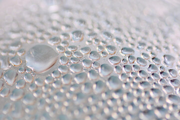 Dew drops on clear glass
