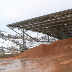 Square crop Pavilion in Salt Lake City with snowy mountain and cloudy sky in the background