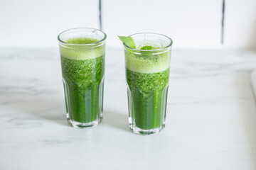 Healthy green vegan smoothie with spinach leaves, spirulina and snack for detox in summer days