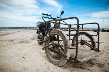 Old bicycle three wheeled on the beach in Mexico, Progreso.