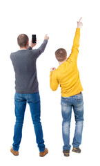 Back view of two man in sweater with mobile phone.