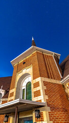 Vertical crop Exterior of a church in Provo Utah with brick wall under vivid clear blue sky