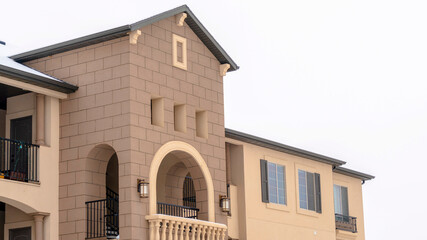 Panorama frame Apartment with snowy front gable roof and balustrade on the arched balcony