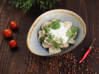 Dumplings with meat and sour cream