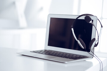 Call center and communication support, customer service help desk. VOIP headset on laptop computer