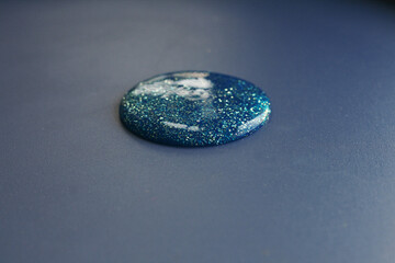 shiny round substance on a dark background
